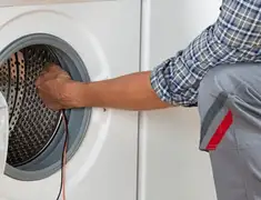 Dryer repair technician diagnosing and servicing a clothes dryer in Dayton, OH