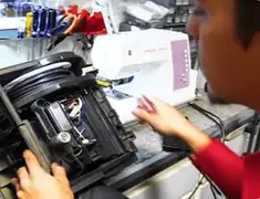 Vacuum repair technician servicing internal components on a workbench in Dayton, OH