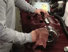 Vacuum repair technician cleaning and servicing a vacuum motor in Dayton, OH
